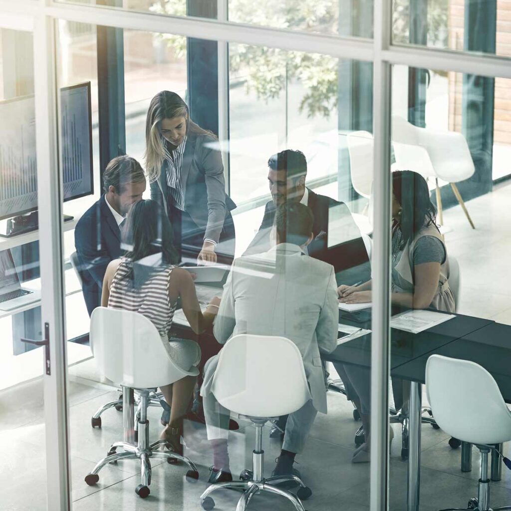 Fractional CMO - A meeting of business people in a room with glass windows