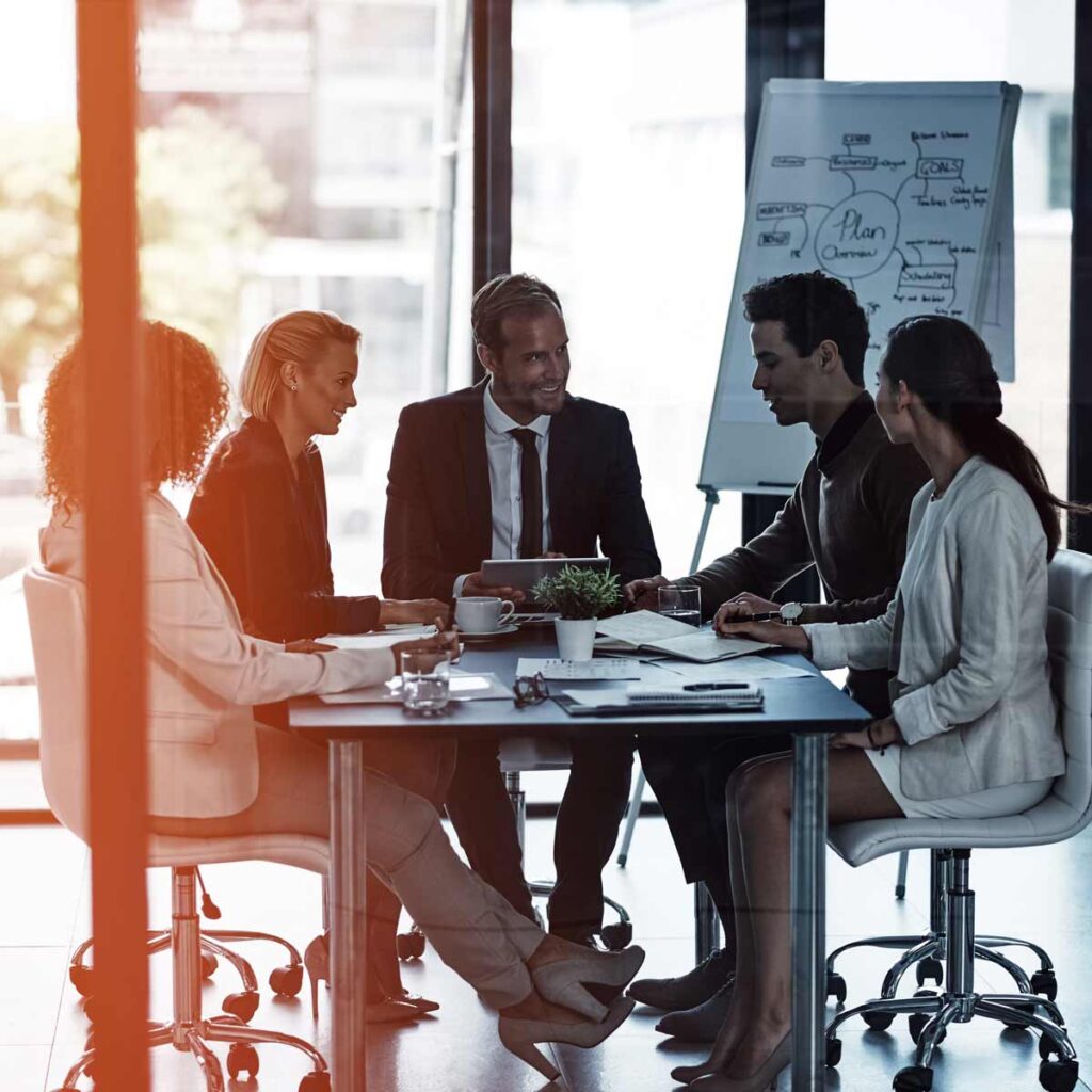 The Fractional CMO — Business meeting conducted in a boardroom with glass walls